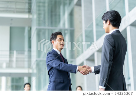 Businessman to shake hands negotiate business image 54325367