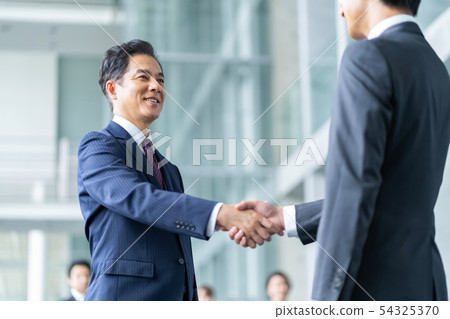 Businessman to shake hands negotiate business image 54325370
