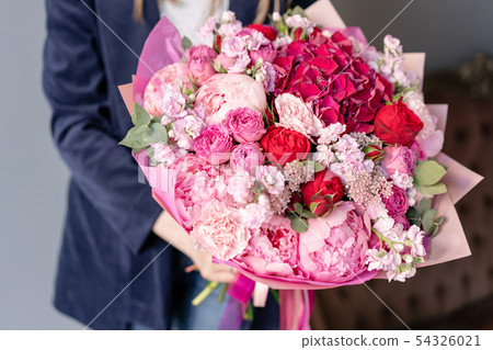 Pink peonies and red hydrangea. Beautiful bouquet of mixed flowers in woman hand. Floral shop Pink peonies and red hydrangea. Beautiful bouquet of mixed flowers in woman hand. Floral shop 54326021