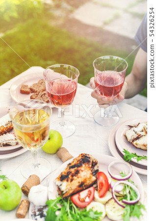 People drink rose and white wine. Dinner 54326254