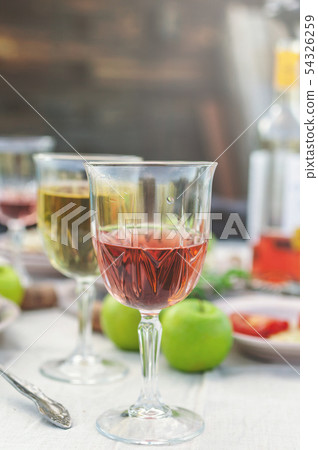 Glasses of white and rose wine, grilled fish 54326259