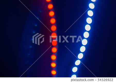 Red and blue blurry neon bokeh lights on black. 54326922