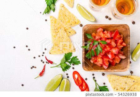 Mexican food salsa, chips and tequila shots with Mexican food salsa, chips and tequila shots with 54326938