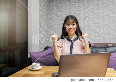 Happy asian businesswoman in the gesture yes!.  54329762