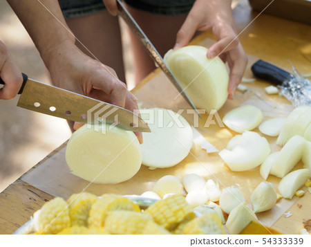 Cutting vegetables in preparation for BBQ Cutting vegetables in preparation for BBQ 54333339