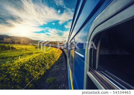 Blue train moving in a picturesque summer landscape 54334463