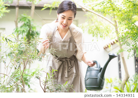 Young woman watering at Jouro Gardening 54334931