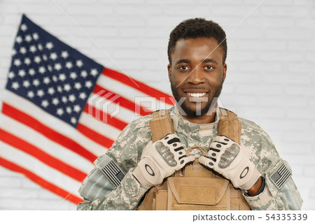 Happy soldier wearing Americans army uniform and armour. Happy soldier wearing Americans army uniform and armour. 54335339