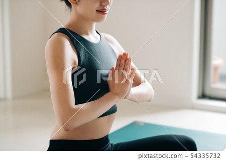 Young woman doing yoga Japanese meditation concentration 54335732
