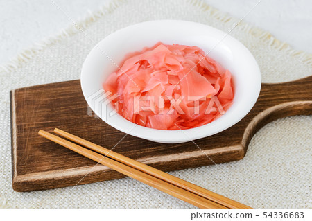 Pickled ginger in a white bowl and chopsticks Pickled ginger in a white bowl and chopsticks 54336683