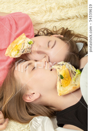 girls overeat pizza 54339619