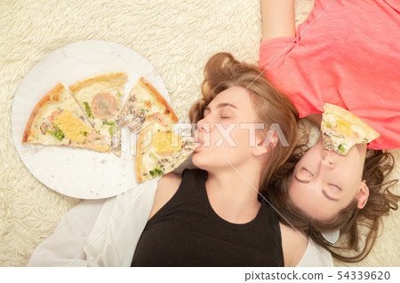 girls overeat pizza 54339620