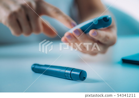 Blood Sugar Testing with Portable Glucometer Blood Sugar Testing with Portable Glucometer 54341211