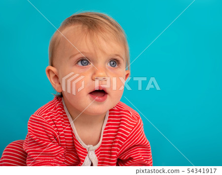 Happy toddler girl over blue background Happy toddler girl over blue background 54341917