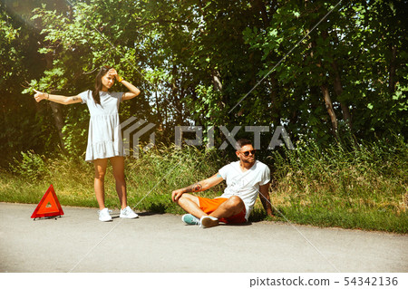 Young couple traveling on the car in sunny day 54342136