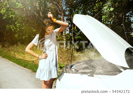 Young woman traveling on the car in sunny day Young woman traveling on the car in sunny day 54342172