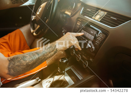Young man preparing for vacation trip on the car in sunny day 54342278