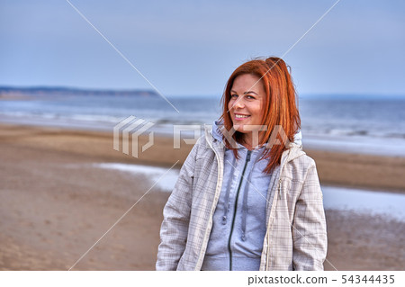 Portrait of a laughing middle-aged woman with red Portrait of a laughing middle-aged woman with red 54344435