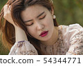 Young woman suffering from a Korean 54344771