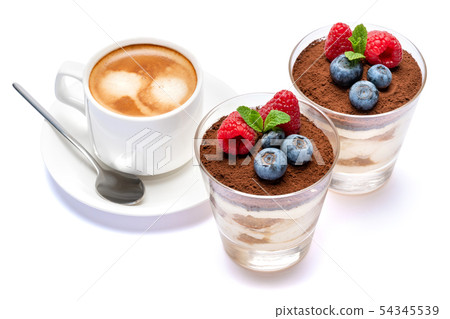Cup of cofee and Classic tiramisu dessert with blueberries and raspberries in a glass isolated on a Cup of cofee and Classic tiramisu dessert with blueberries and raspberries in a glass isolated on a 54345539