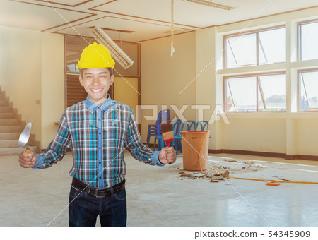 engineer smile with hand holding triangle trowel 54345909