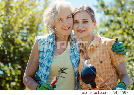 Woman gardening together in summer 54345981