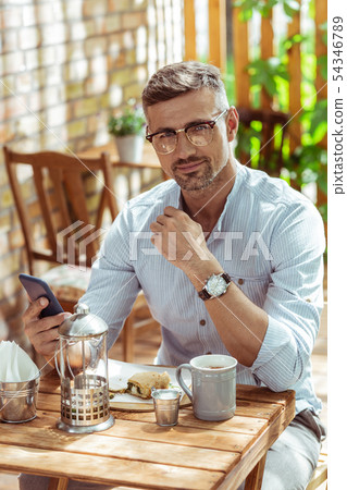 Handsome man sitting in a summer cafe in the morning. 54346789