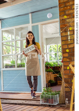 Beautiful woman just opened her flower shop. 54347813