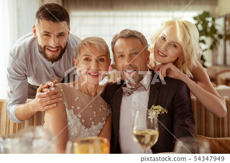 Young man and woman hugging parents getting married 54347949