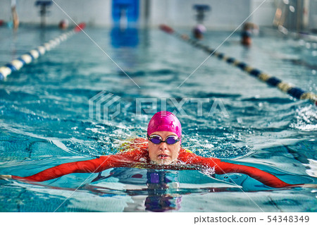 Female athlete in a red-yellow swimsuit is 54348349