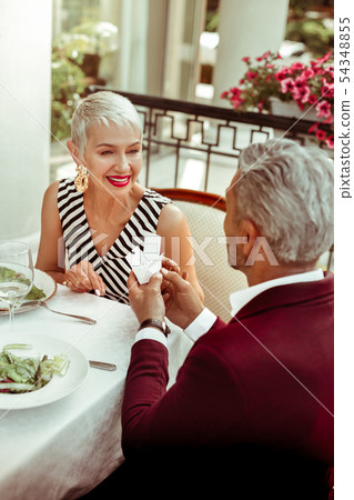 Grey-haired mature businessman presenting jewelry for his wife 54348855