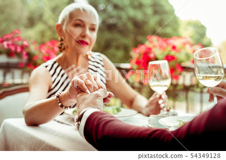 Wife touching hand of her supportive loving husband Wife touching hand of her supportive loving husband 54349128