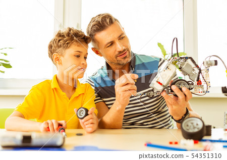 Positive bearded man helping his student during the class 54351310