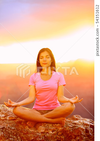 Meditating yoga woman at sunset in Grand Canyon 54351612