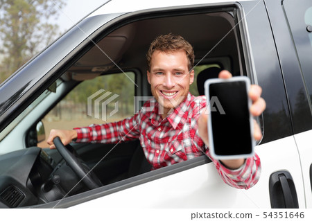Smartphone man in car driving showing smart phone Smartphone man in car driving showing smart phone 54351646