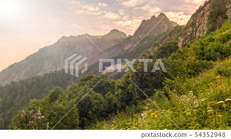 Mountain view in a light haze at sunset Mountain view in a light haze at sunset 54352948