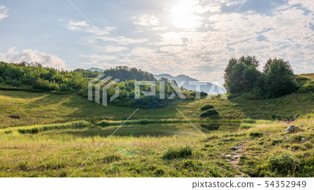 View of a mountain lake with smooth water 54352949