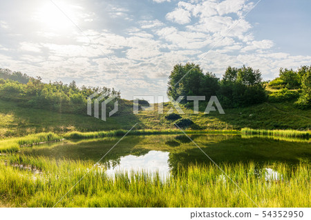 View of a mountain lake with smooth water View of a mountain lake with smooth water 54352950