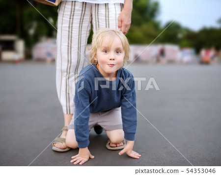 Little playful boy having fun during walking with Little playful boy having fun during walking with 54353046