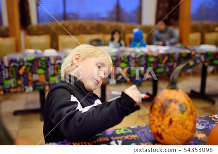 Little boy in scary skeleton costume paints 54353098