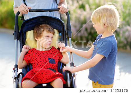 A woman with a boy and a disabled girl in a A woman with a boy and a disabled girl in a 54353176