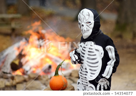 Little boy in scary skeleton costume on background 54354077