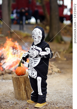 Little boy in scary skeleton costume on background Little boy in scary skeleton costume on background 54354472