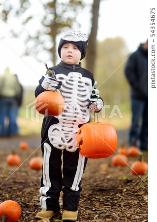 Little boy in scary skeleton costume at halloween 54354675