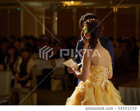 A bride reading a letter at a banquet hall A bride reading a letter at a banquet hall 54355259