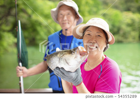 happy Senior couple fishing at the lakeside 54355289