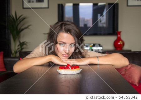 Pretty girl Looking to strawberry cake Pretty girl Looking to strawberry cake 54355342