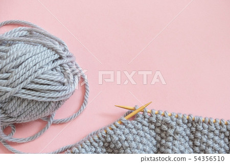 Piece of grey knitted fabric on bamboo wood Piece of grey knitted fabric on bamboo wood 54356510
