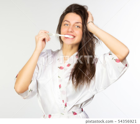 Woman in peignoir with toothbrush Woman in peignoir with toothbrush 54356921