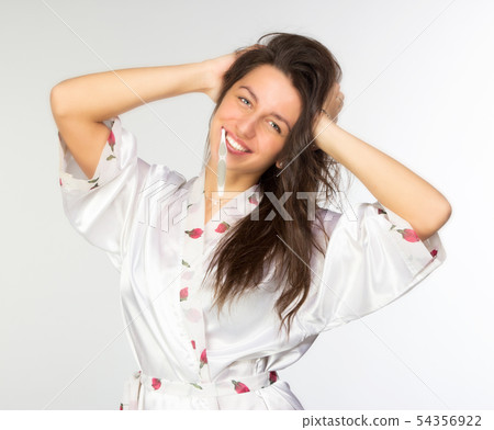 Woman in peignoir with toothbrush Woman in peignoir with toothbrush 54356922